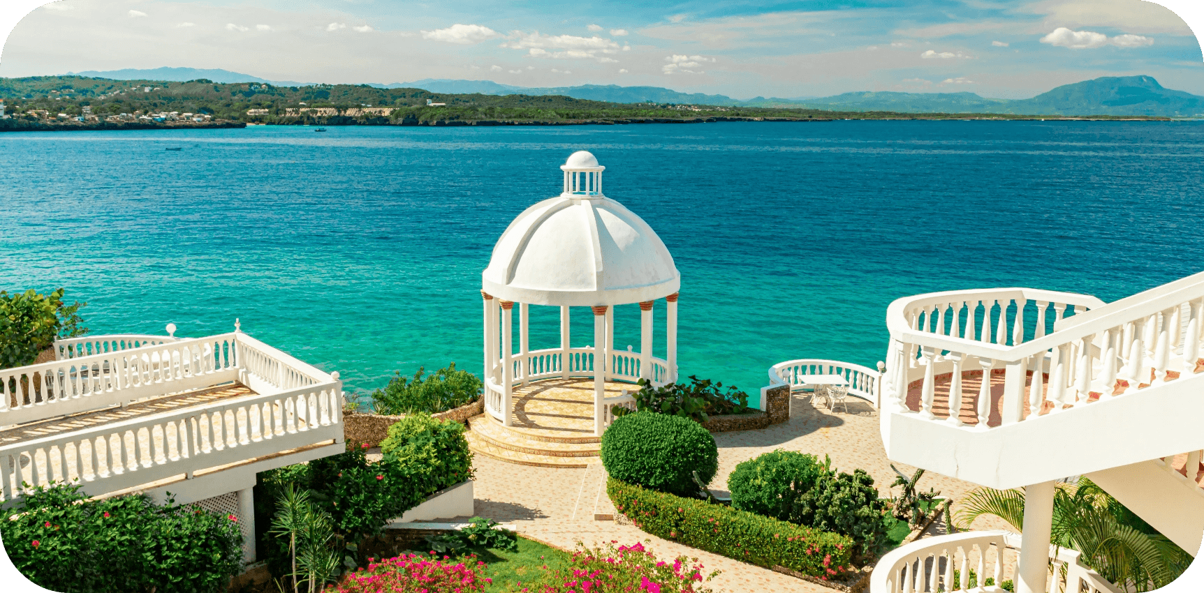 USE - TOP - Beautiful-white-gazebo-and-tropical-flower-garden-on-Caribbean-ocean-background,-summer-mountain-view-,-Sosua,-Puerto-Plata,-Dominican-Rep@2x